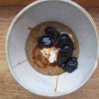 Amaranth porridge with prunes stewed in malt